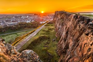 View of Edinburgh and Edinburgh castle from Arthur's Seat peak at sunset