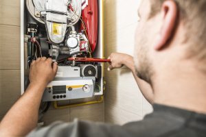 Worker fixing an electricity metre