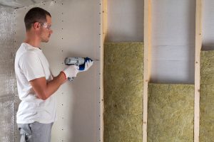 Man fitting insulation