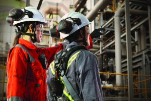 Two workers wearing hard hats during a site inspection